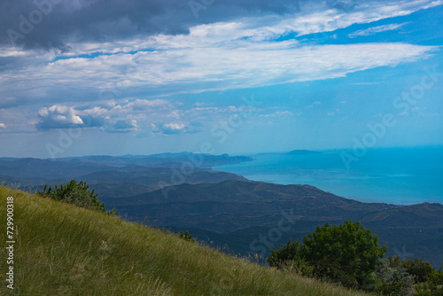 View from the top of Mount Demerdzhi to the mountainous green valley and the sea. Landscape