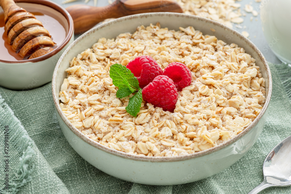 Bowl of porridge or oatmeal with fruits close up. Breakfast concept. Bowl of porridge or oatmeal with fruits close up. Breakfast concept.