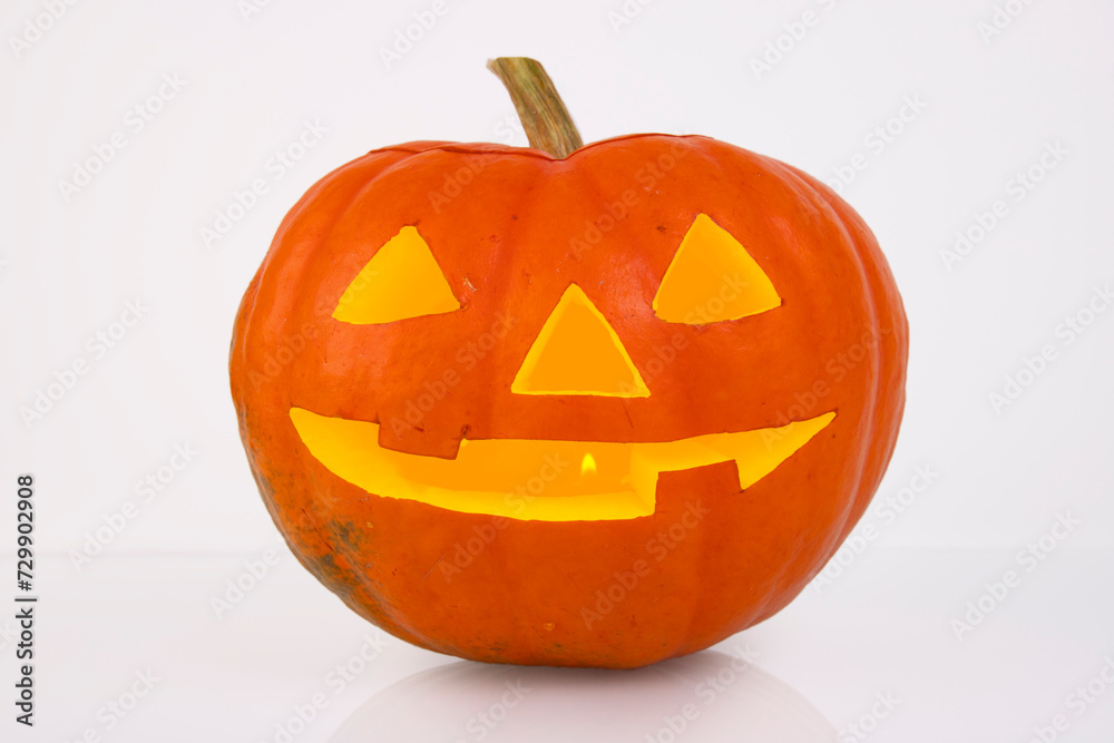 Orange pumpkin with glowing eyes, nose and mouth on a white background. halloween Orange pumpkin with glowing eyes, nose and mouth on a white background. halloween
