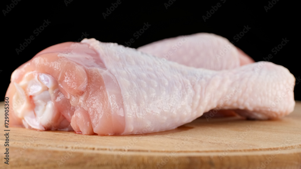Fresh raw chicken legs isolated on black background Fresh raw chicken legs isolated on black background