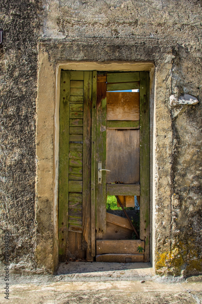 An old wooden door in an abandoned house in the Stari Grad historic centre of the coastal town of Novi Vinodolski, Primorje-Gorski Kotar County, Croatia An old wooden door in an abandoned house in the Stari Grad historic centre of the coastal town of Novi Vinodolski, Primorje-Gorski Kotar County, Croatia