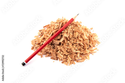 red wooden pencil on sawdust. sawdust pile and red pencil on white background