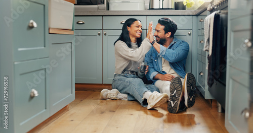Bild auf Leinwand Couple, coffee and sitting on floor in kitchen for quality time or fun to celebrate or discussion
