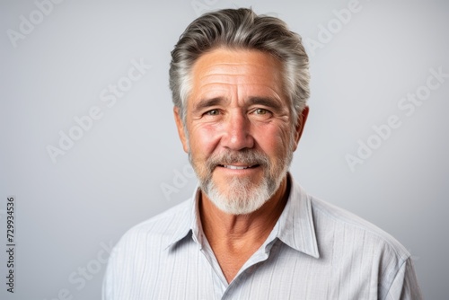 Handsome middle aged man with grey beard and mustache on grey background