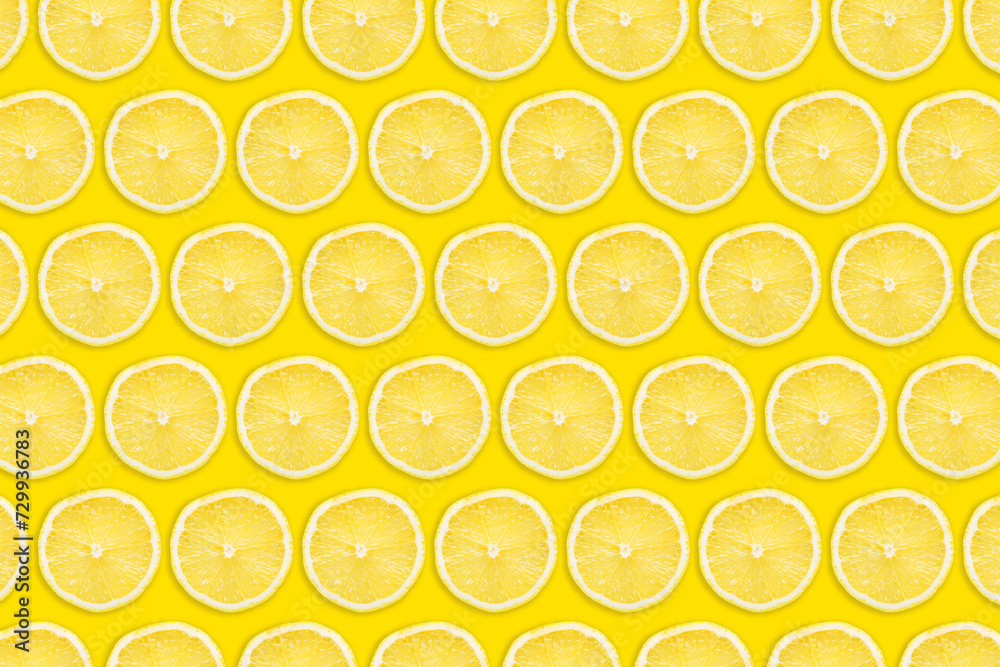 Vibrant yellow lemon slices isolated on yellow background. Fruit sections design texture. Vitamin diet pattern. Top view flat design. Vivid colors fruit. Cross section fruit pattern design.