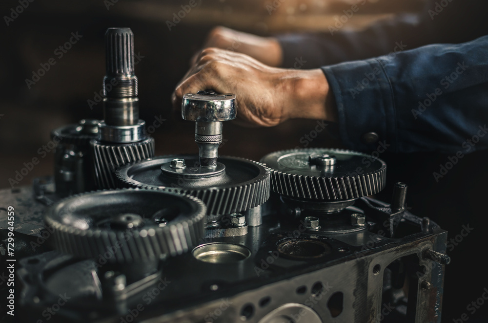 Car spare parts.The cylinder head of an internal combustion engine. Close-up of the mechanic's hands. Product control. Installation of condensers. Preparation for installation. Repair and maintenance.