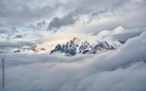 Wonderful minimalist landscape with big snowy mountain peaks above low clouds. © Gheorghe
