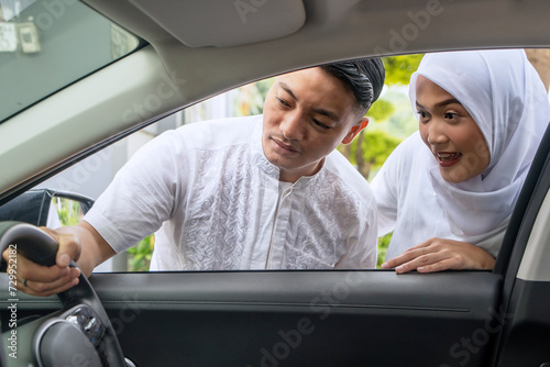Happy couple muslim asian couple looking at a car interior in an auto show