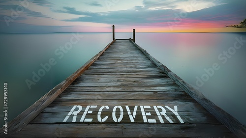 Recovery concept on a wooden dock in the middle of the ocean at sunset, with the word recovery written on it. - 1