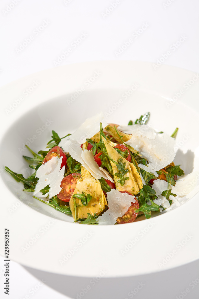 Artichoke and tomato salad with shaved Parmesan cheese Artichoke and tomato salad with shaved Parmesan cheese