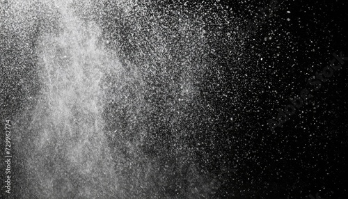 Abstract splashes of water on a black background. Freeze motion of white particles. Rain, snow overlay texture