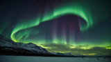 northern lights over snow-covered mountains