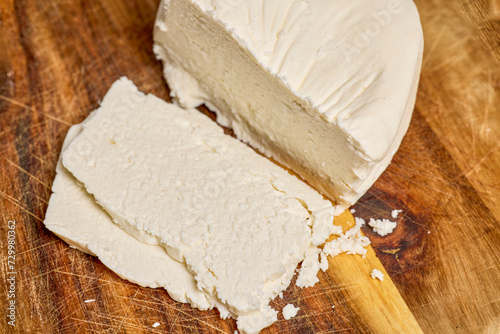 Sliced Telemea cheese on a wooden board. photo