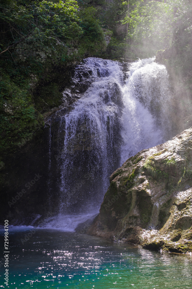 Naklejka premium turquoise crystal clear water of a waterfall of a mountain Alpine river