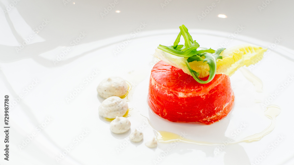 Close up of stuffed red beef carpaccio with rucola and endive salad leaves on a white background Close up of stuffed red beef carpaccio with rucola and endive salad leaves on a white background