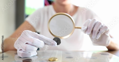 Numismatist study collection of ancient coins at table. Studying history of coinage and monetary circulation and valuation photo