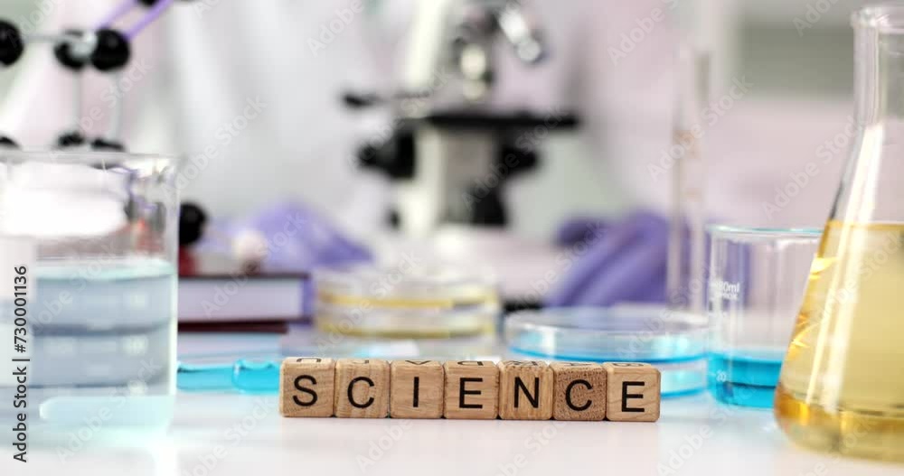 Word science with microscope and liquids in flask. Science education and laboratory research and development concept Word science with microscope and liquids in flask. Science education and laboratory research and development concept