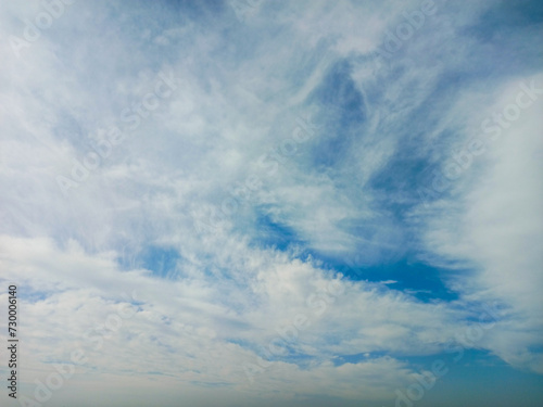Background blue sky with fluffy white clouds, creating a picturesque scene of tranquility and beauty.