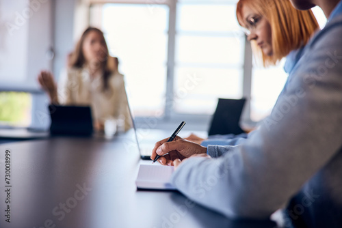 Photo of business females having a meeting in the meeting room, making some plans for the company. © bnenin