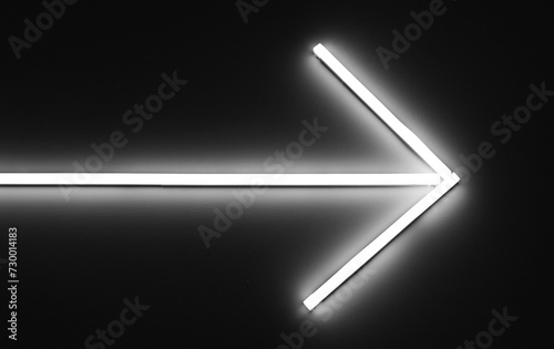 White neon light arrow sign background.