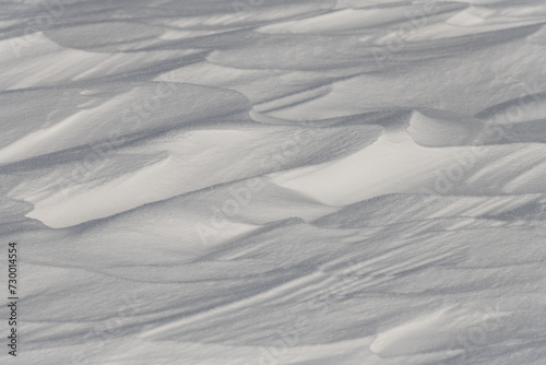 Wind-formed snow drifts on a sunny day