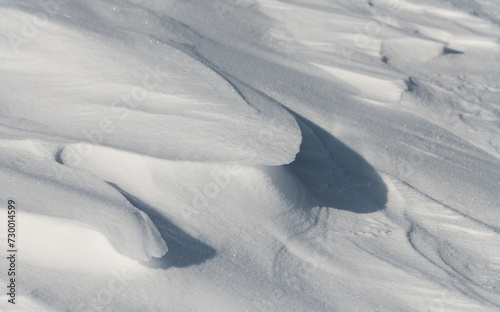 Wind-formed snow drifts on a sunny day