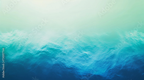 Abstract representation of ocean waves with a smooth texture, transitioning from teal to deep blue, evoking a sense of calm and depth.