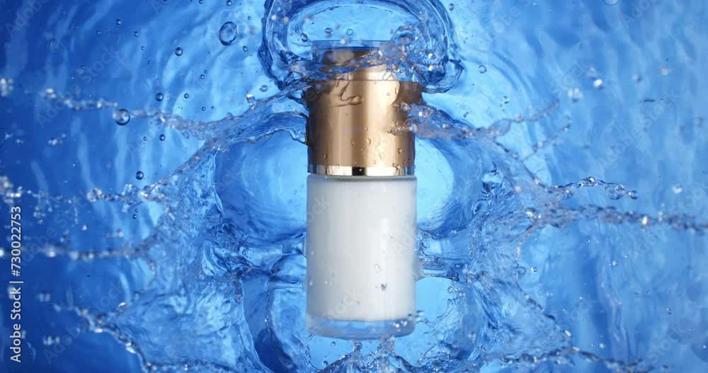 Super slow motion macro of unbranded cosmetic skincare moisturising beauty product glass bottle with dispenser and golden tap is falling into clear pure water with splashing waves and drops at 1000fps Super slow motion macro of unbranded cosmetic skincare moisturising beauty product glass bottle with dispenser and golden tap is falling into clear pure water with splashing waves and drops at 1000fps