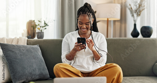 Happy, black woman and credit card with phone on sofa for online shopping, payment code and fintech at home. Mobile banking, finance and password to upgrade subscription, ecommerce and money savings photo