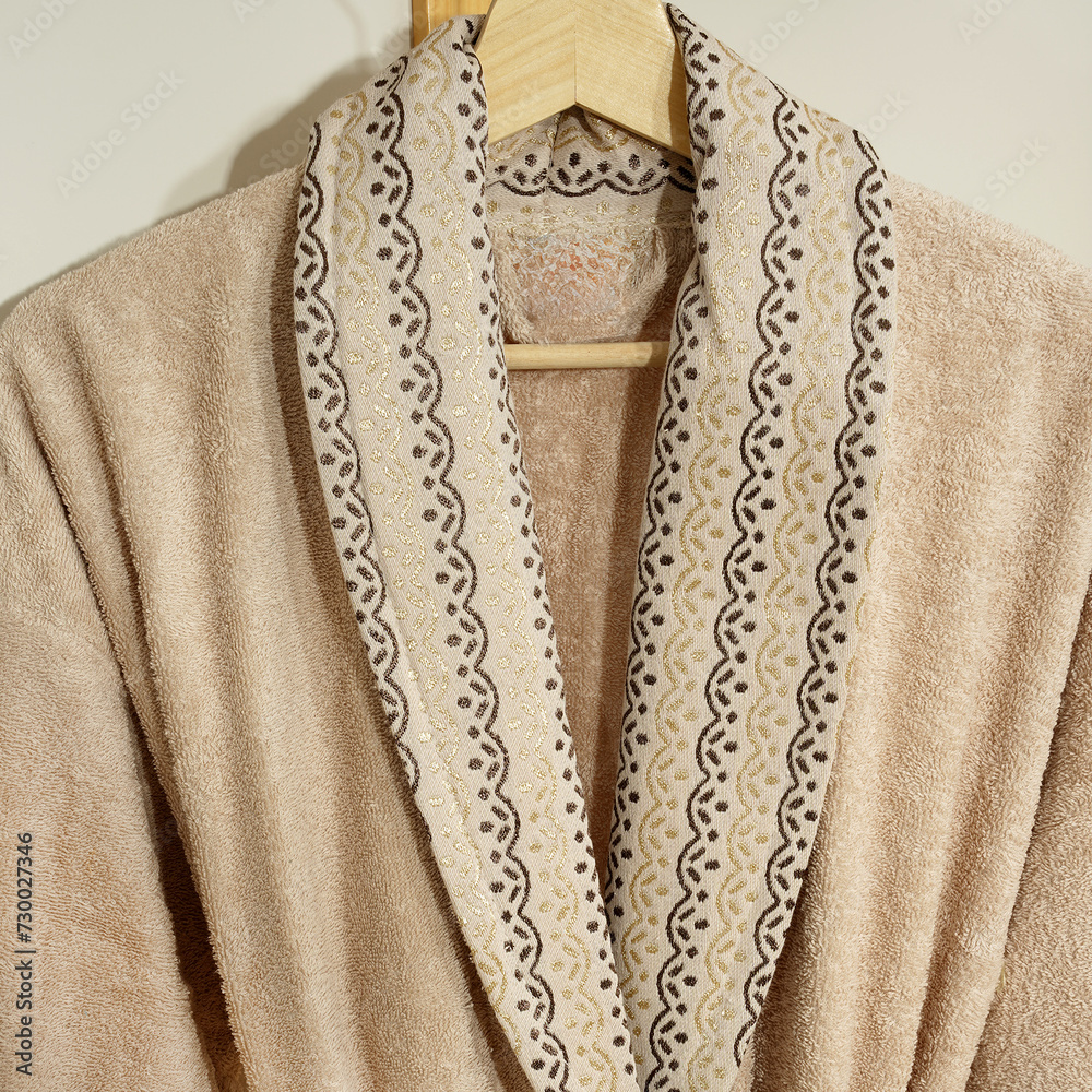 Bathrobe set - Hanger with clean bathrobe and towel on light wall bathrobe mockup Bathrobe set - Hanger with clean bathrobe and towel on light wall bathrobe mockup