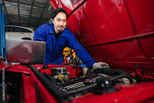 Portrait Asian Japanese male mechanic worker portrait in auto service workshop car maintenance center replace fix auto engine part