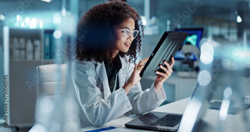 Tablet, laptop and woman scientist in lab working on medical research, project or experiment. Science, career and female researcher with digital technology and computer for pharmaceutical innovation. photo