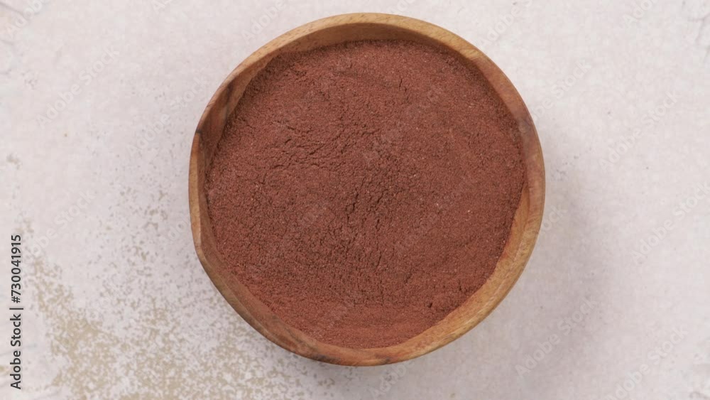 cinnamon powder in bowl top view cinnamon powder in bowl top view
