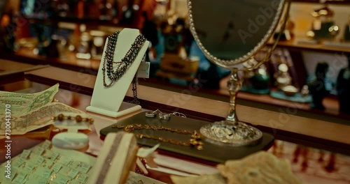 expensive jewelry with precious stones on showcase of shop in 19 century, closeup view, 4K, Prores