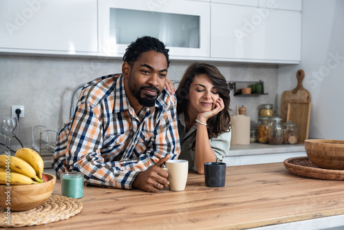 Simple living. Young couple drinking their first morning coffee in the kitchen discussing improving the quality of their love relationship  respect they have for each other and their plans for the day