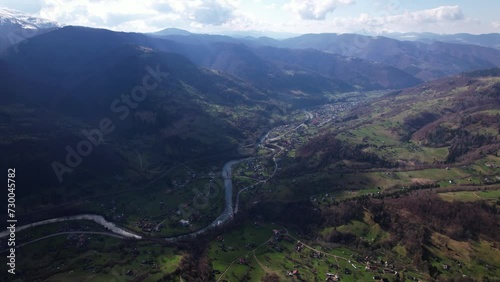 Aerial view on a carpathian mountain valley with a village Kvasy and river Tisa at spring in Ukraine photo