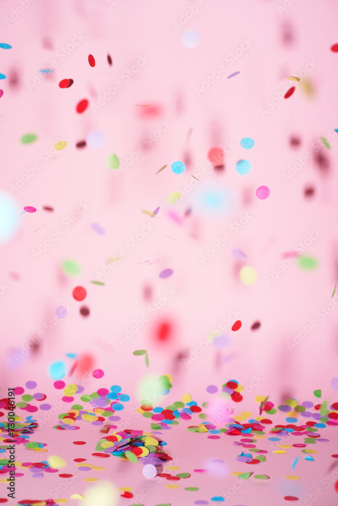 festive confetti in front of a colorful pink rose background