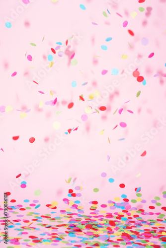 festive confetti in front of a colorful pink rose background