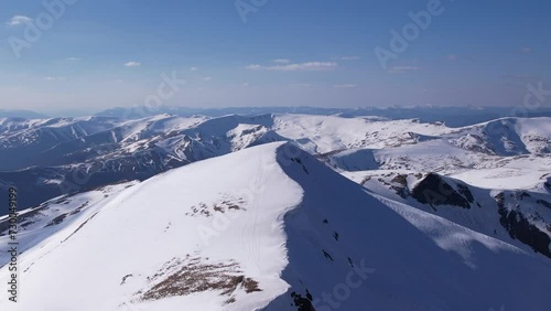 Mountain peak covered with snow aerial footage in Ukrainian Carpathians photo