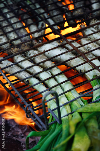 Close-up of sweet onions known as "calçots" in a barbecue. Typical catalan food.