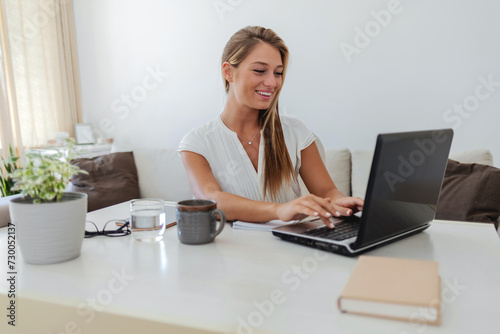Laptop, remote work and Caucasian woman with smile in home for inspiration in planning, strategy and business project. Technology, success and happy girl on computer with ideas, goals and motivation