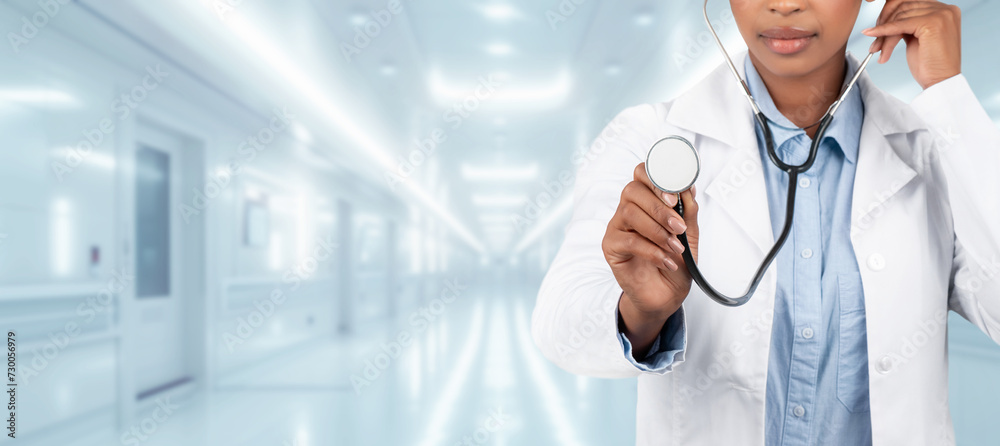 A confident woman doctor in a white coat holding a stethoscope A confident woman doctor in a white coat holding a stethoscope
