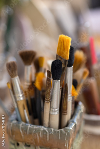 Brushes of different sizes and colors for potter's work. Close-up