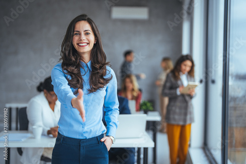 Happy office employee giving hand for shaking . Arm of business woman offering handshake. Professional welcoming colleague or new partner. HR manager hiring greeting at job interview. Close up shot