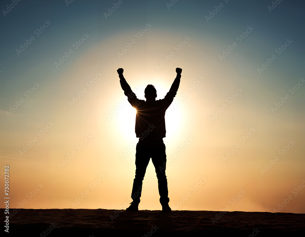 Silhouette of a person with both arms raised in victory.  Concepts of success and achievement.