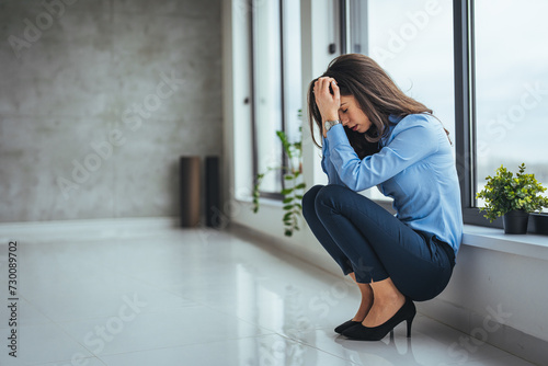 Businesswoman having problems in the office. Shot of a young businesswoman looking stressed out in an office. Shot of an attractive young businesswoman sitting alone in the office and feeling stressed
