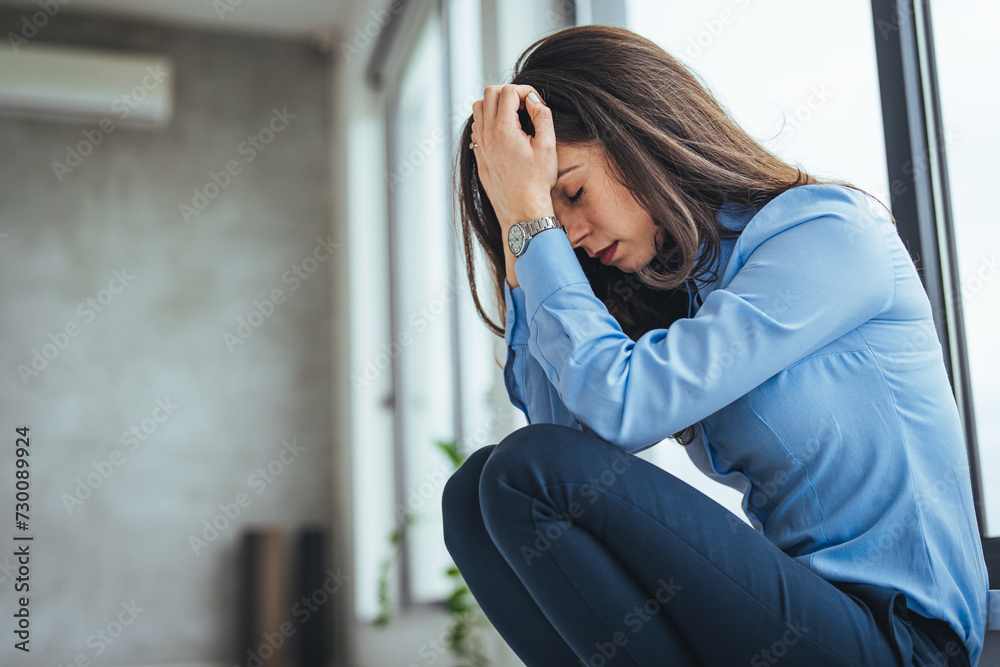 Shot of a stressed businesswoman sitting on the floor outside the boardroom. Tired or depressed businesswoman sitting on the floor in front of office with her hands covering her eyes. Shot of a stressed businesswoman sitting on the floor outside the boardroom. Tired or depressed businesswoman sitting on the floor in front of office with her hands covering her eyes.