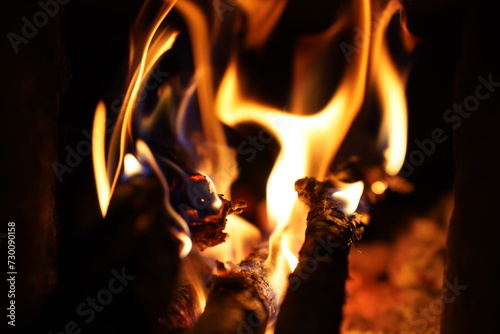 Yellow bright bonfire on black background, horizontal view. Orange flame of campfire in night. © Sopear