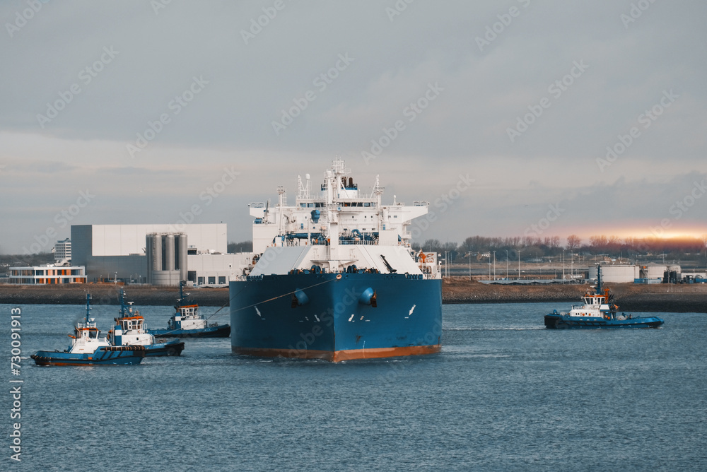 LNG Tanker Mooring In The International Trade Port. Gas Transportation Facility. Natural Gas Shipping And Logistics LNG Tanker Mooring In The International Trade Port. Gas Transportation Facility. Natural Gas Shipping And Logistics