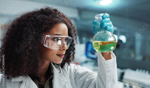 Scientist, woman and chemical with glasses in laboratory for chemistry experiment, test sample or research. Science, person and liquid inspection for clinical analysis, expert investigation and study